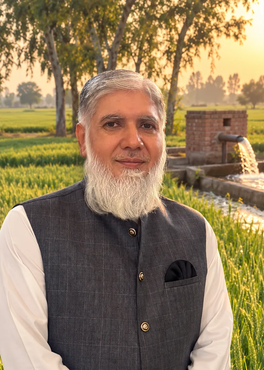 Tuyyab Bukhari standing in a wheat field on his farm in Punjab